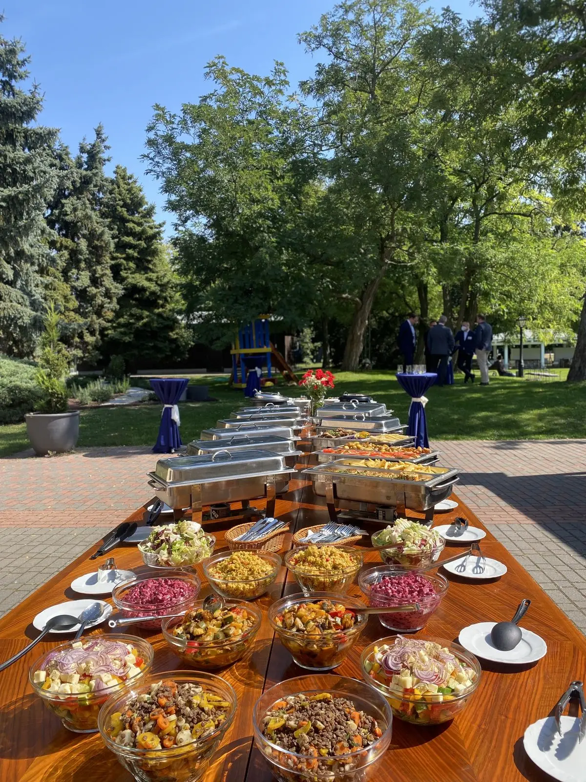People buying food from stalls at an outdoor event